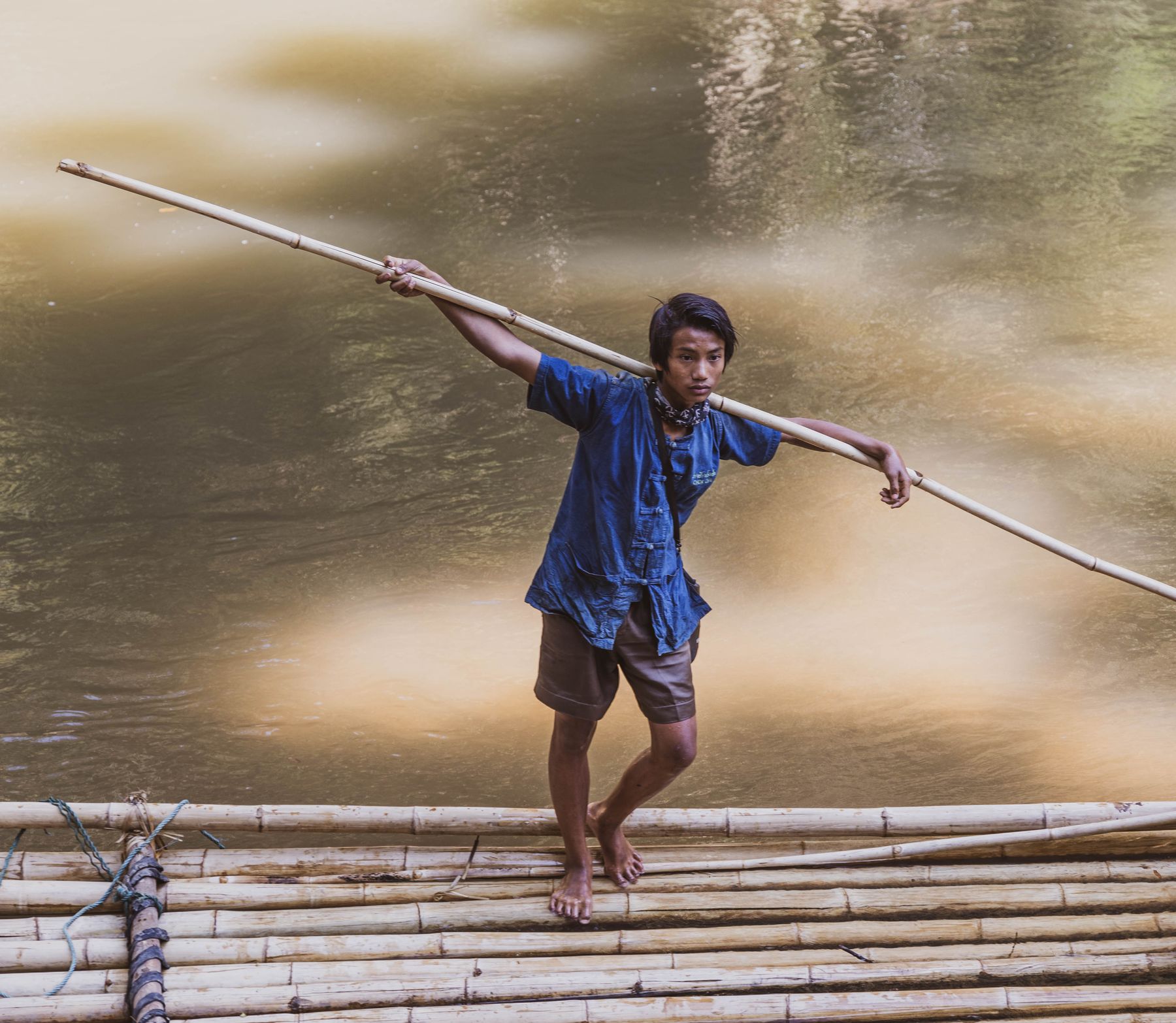 Thai Boy on Bamboo Raft with Bamboo Pole